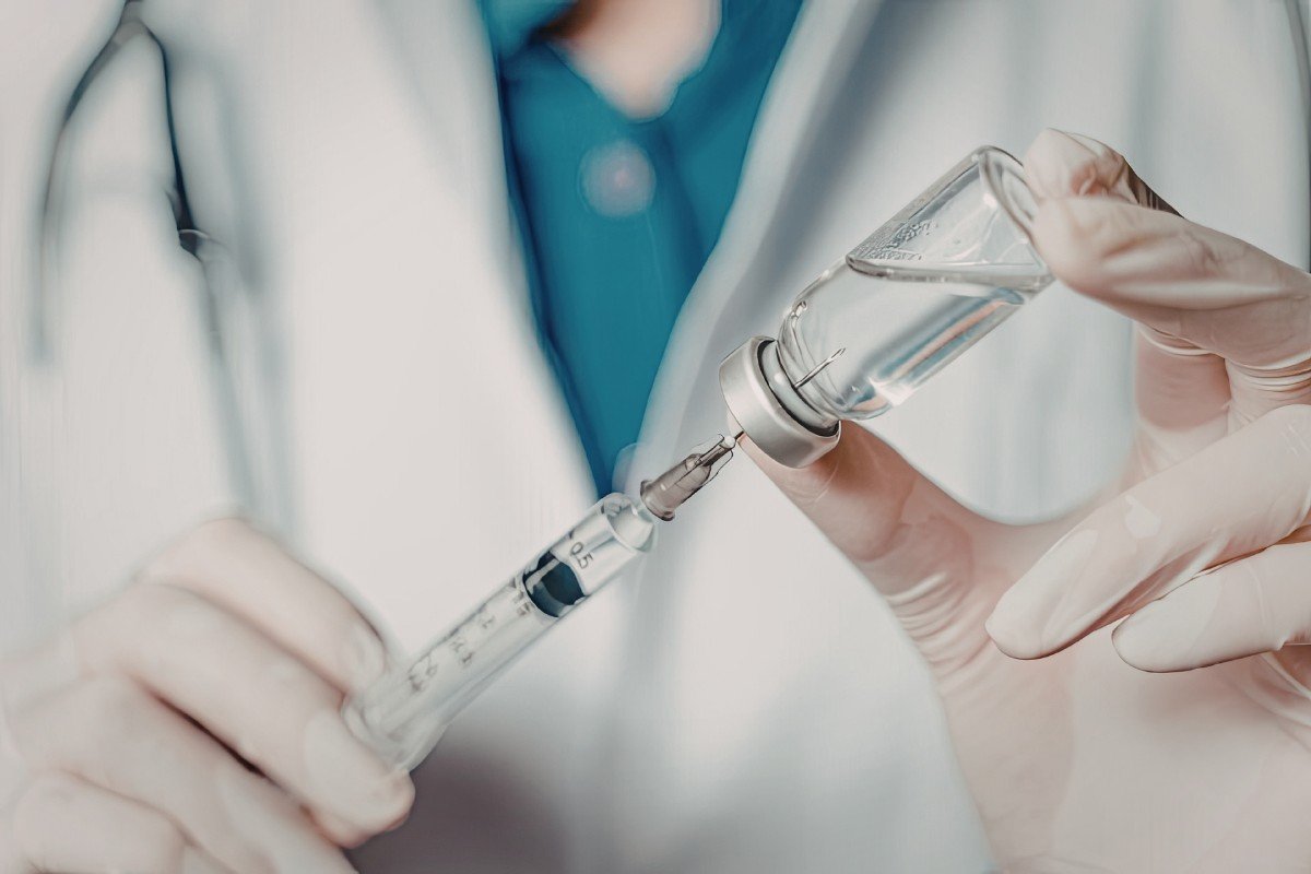 A veterinarian prepares a vaccine.
