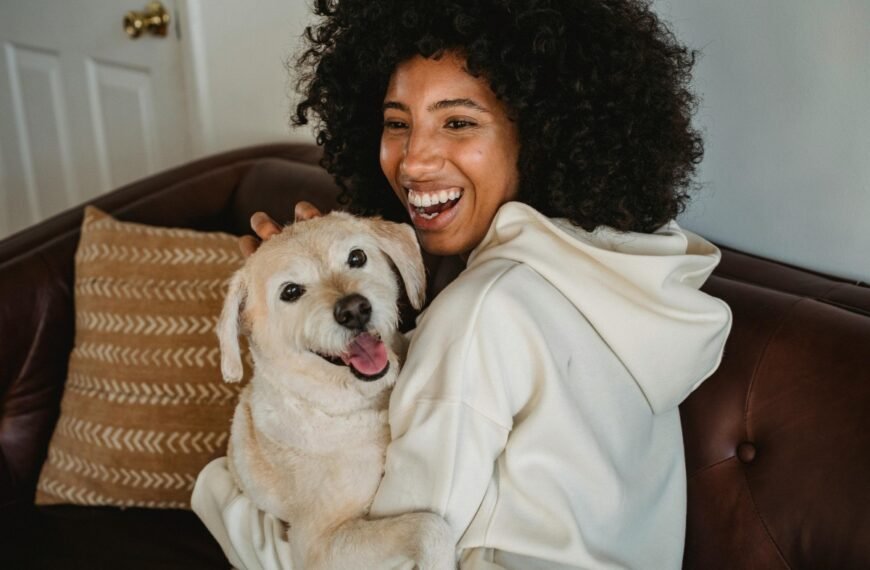 A young woman embraces her new dog.